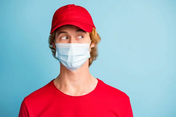 Photo of working guy look empty space wear medical face cold safe mask headwear isolated on blue color background — Stock Fotó