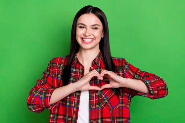 Photo of brunette flirty millennial lady show heart wear red shirt isolated on green color background — Stock Photo, Image