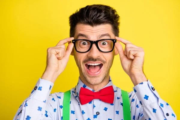 Primer plano retrato de chico alegre atractivo tocando especificaciones grandes noticias aisladas sobre fondo de color amarillo brillante —  Fotos de Stock