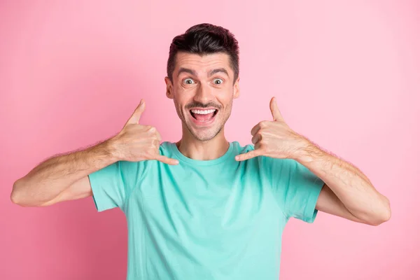 Photo of young handsome man happy positive smile gesture fingers call me sign isolated over pink color background — Stock Photo, Image