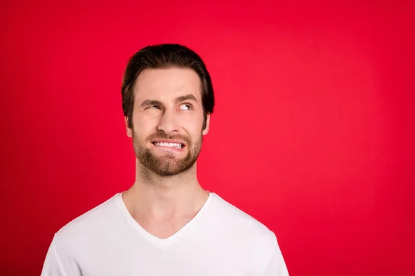 Photo of unhappy upset young man look empty space problem bad mood isolated on red color background — Stock Photo, Image