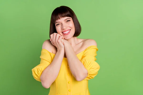 Photo of attractive adorable young woman hold hands face thankful gift isolated on green color background — Stock Photo, Image