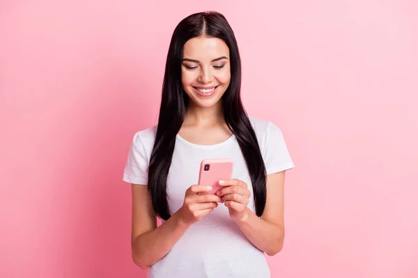 Portret van aantrekkelijke vrolijk gericht meisje met behulp van apparaat gadget browsen webnieuws 5g geïsoleerd over roze pastel kleur achtergrond — Stockfoto