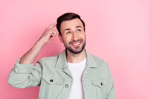 Photo of nice optimistic brunet man look empty space wear grey shirt isolated on pastel pink color background — Stock Photo, Image