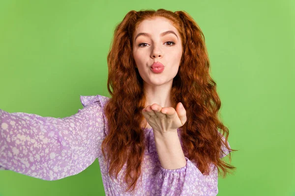 Photo of coquette ginger hairstyle millennial lady do selfie blow kiss wear violet blouse isolated on green color background — Stock Photo, Image