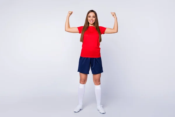 Full size zdjęcie najlepszy piłkarz zespół dziewczyna wygrać wszystkie mistrzostwa świata turniej pokazać mięśnie nosić czerwony t-shirt niebieski szorty białe długie skarpety buty jednolite odizolowany szary kolor tło — Zdjęcie stockowe