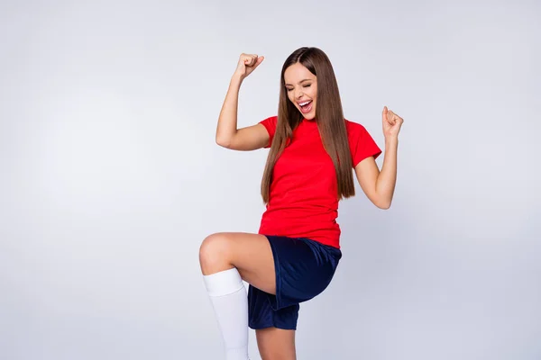 Yes we win Delighted crazy soccer player girl raise fists celebrate national uefa football team win scream enjoy rejoice wear red t-shirt blue shorts white socks isolated gray color background — Stock Photo, Image