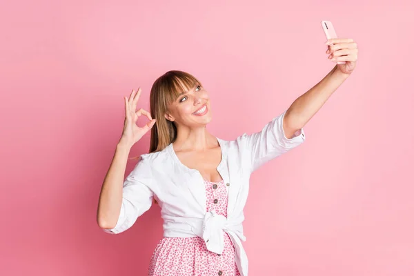 Foto portret vrouwelijke student het nemen van selfie smartphone tonen oke teken vingers geïsoleerd op pastel roze kleur achtergrond — Stockfoto