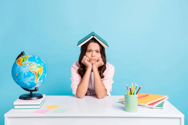 Foto de joven bastante infeliz niña estresada sostener libro una cabeza cansada estudiar aislado sobre fondo de color azul — Foto de Stock