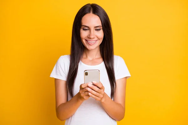 Photo portrait of brunette influencer browsing internet with cellphone isolated on vivid yellow color background — Stock Photo, Image