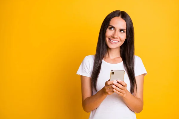 Photo portrait of female student typing comment in social media looking copyspace isolated on vibrant yellow color background — Stock Photo, Image