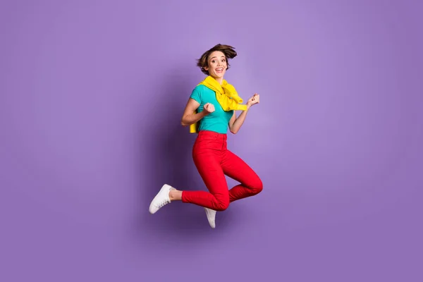 Full length photo of champion girl jump wear tied pullover t-shirt trousers sneakers isolated violet color background — Stock Photo, Image