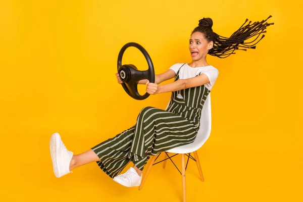 Full length photo of funky scared dark skin woman dressed striped outfit sitting screaming driving car isolated yellow color background — Stock Photo, Image