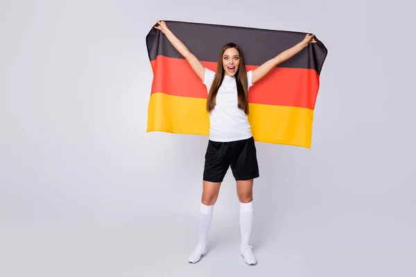 Full body photo of fan lady raise big germany flag support country world soccer league cheerleader wear football uniform t-shirt shorts shoes knee socks isolated white color background — Stock Photo, Image