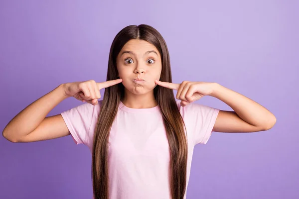 Foto de encantador engraçado jovem usar rosa t-shirt dedos apontando bochechas inchadas isolado cor violeta fundo — Fotografia de Stock