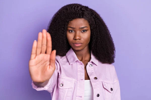 Fotografie mladé vážné krásné africké ženy ukazující stop znamení omezení popírat izolované na fialové barvy pozadí — Stock fotografie