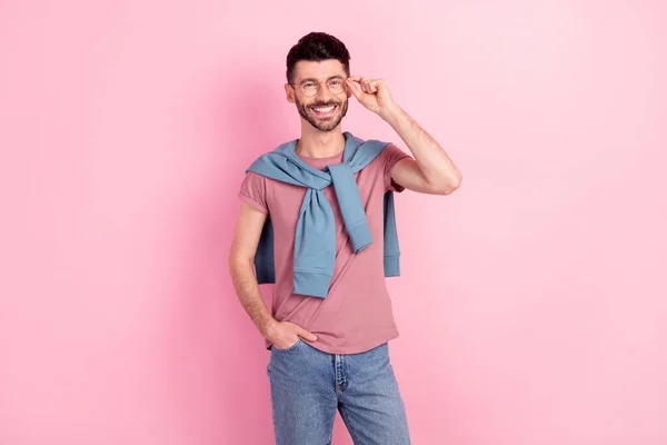 Foto von attraktiven fröhlichen jungen Mann halten Hand Tasche Jeans tragen Brille gute Laune isoliert auf rosa Hintergrund — Stockfoto