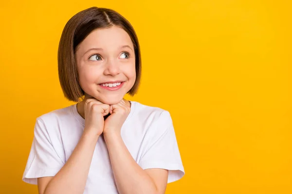 Foto retrato menina com bob hairdress sorrindo curioso alegre olhando copyspace isolado vibrante cor amarela fundo — Fotografia de Stock