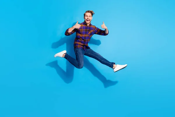 Full length portrait of excited crazy guy show two thumbs up toothy smile rush isolated on blue color background — Stock Photo, Image