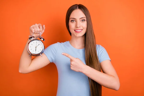 Foto av glada unga lång frisyr dam punkt klocka bära blå t-shirt isolerad på orange färg bakgrund — Stockfoto