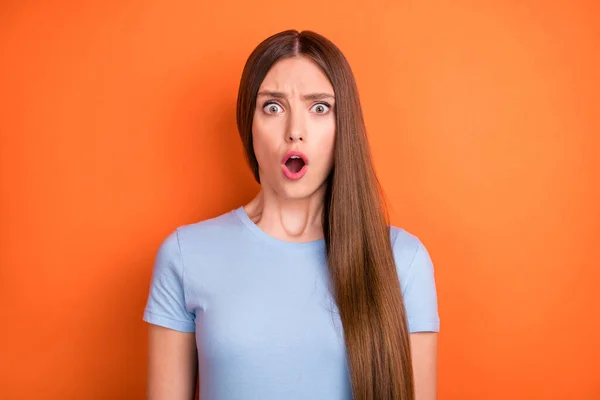 Photo of stressed long hairdo millennial lady open mouth wear blue t-shirt isolated on vivid orange color background — Stock Photo, Image