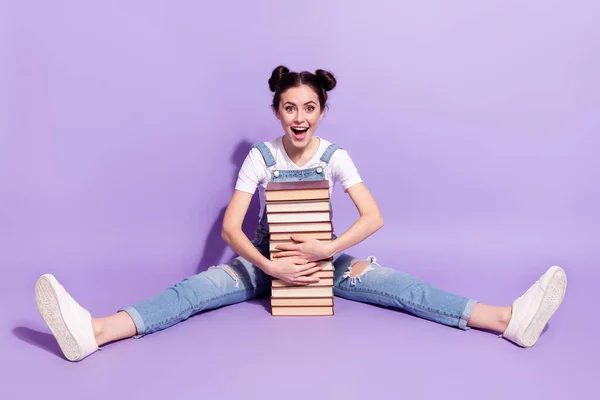 Full size photo of young excited girl happy positive smile sit floor hug books isolated over violet color background — Stock Photo, Image