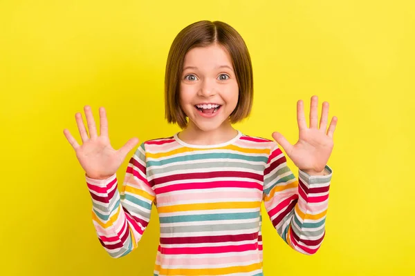 Foto von fröhlichen jungen charmanten kleinen Mädchen halten Hände gute Laune Lächeln isoliert auf gelbem Hintergrund — Stockfoto