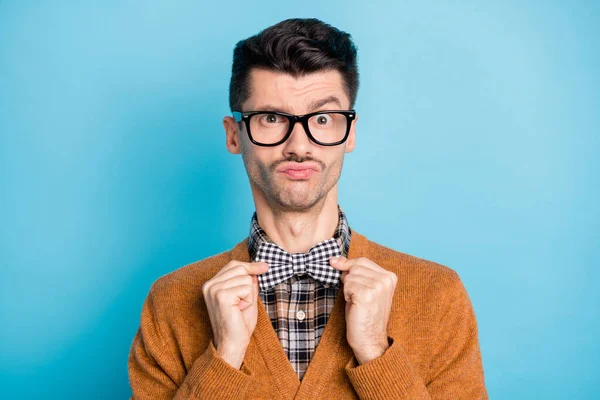 Фото молодого красивого крутого чоловіка, який носить краватку-мішок, фіксують пальці, одягнені в окуляри, ізольовані на синьому кольорі — стокове фото