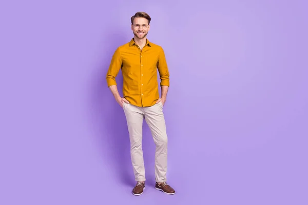 Photo of confident sweet young guy wear casual clothes glasses arms pockets smiling isolated purple color background — Stock Photo, Image