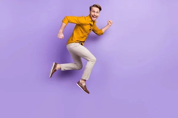 Full length body size view portrait of nice funky glad cheerful guy jumping isolated over violet purple color background — стоковое фото