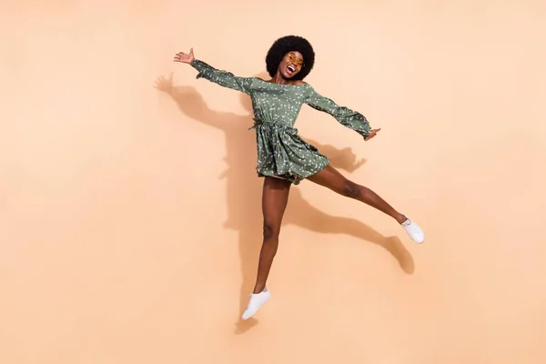 Full body photo of young cheerful black girl happy positive smile have fun jump up isolated over beige color background — Stock Photo, Image