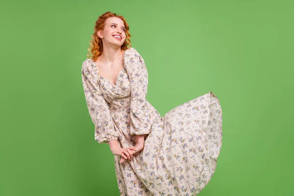 Foto de encantadora mujer alegre joven mirada vacío espacio volar falda primavera aislado sobre fondo de color verde — Foto de Stock
