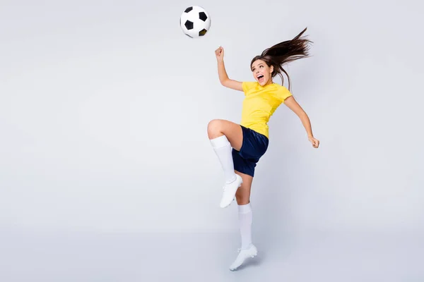 Yeah i catch Full size photo positive excited shocked girl soccer player see foot ball fly try kick scream wear yellow blue white football kit equipment shoes isolated grey color background — Zdjęcie stockowe