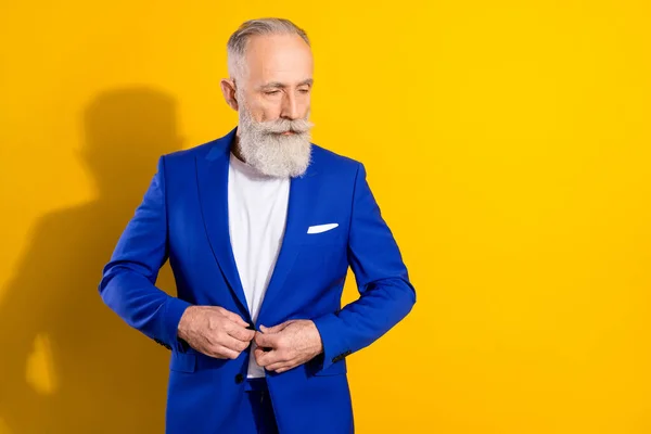 Photo of strict grey beard old man look empty space wear blue jacket isolated on vivid yellow color background — Stock Photo, Image