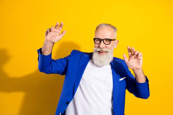 Portrait of positive aged person enjoy partying look empty space have good mood isolated on yellow color background — Stock Photo, Image