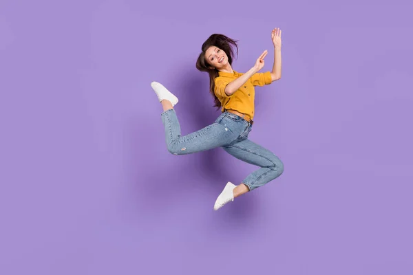 Full length body size photo jumping high girl smiling dancing ballerina wearing jeans isolated pastel purple color background — Stok fotoğraf