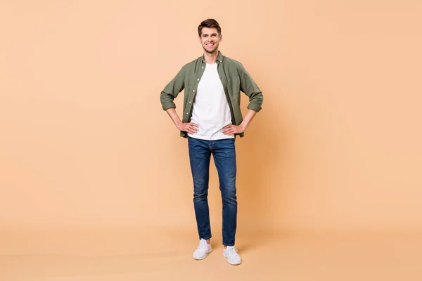 Photo of handsome pretty young gentleman wear khaki shirt walking arms waist smiling isolated beige color background — 스톡 사진