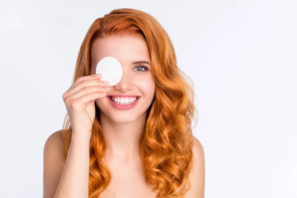 Foto retrato de modelo joven con el pelo rojo rizado sonriendo ojo cubierto con disco de algodón sonriendo feliz aislado sobre fondo de color blanco — Foto de Stock