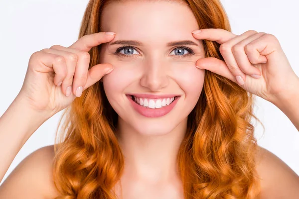 Primer plano foto retrato de modelo joven con el pelo rojo rizado sonriendo mostrando arrugas cerca de los ojos necesitan crema aislada sobre fondo de color blanco — Foto de Stock