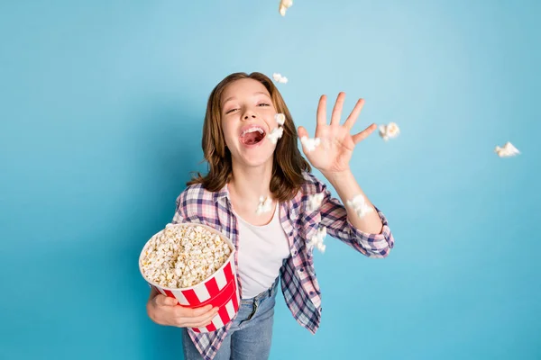 Photo of optimistic red hairdo girl eat pop corn wear shirt jeans isolated on blue color background — Stock Photo, Image