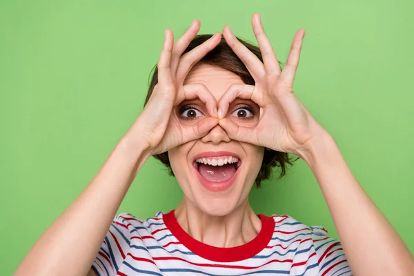 Close-up portret van vrij vrolijk meisje tonen ok-teken als specs hebben plezier geïsoleerd over groen pastel kleur achtergrond — Stockfoto