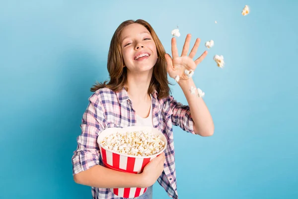 Photo of optimistic red hairdo girl eat pop corn wear shirt jeans isolated on blue color background — Stock Photo, Image