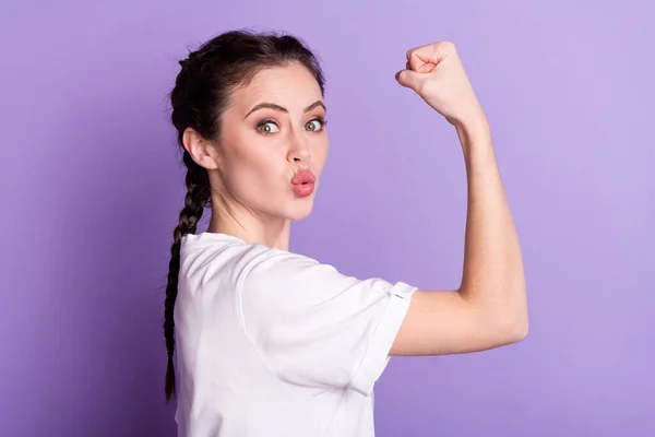 Profile side photo of funky happy young woman send air kiss show biceps win isolated on purple color background — Stock Photo, Image