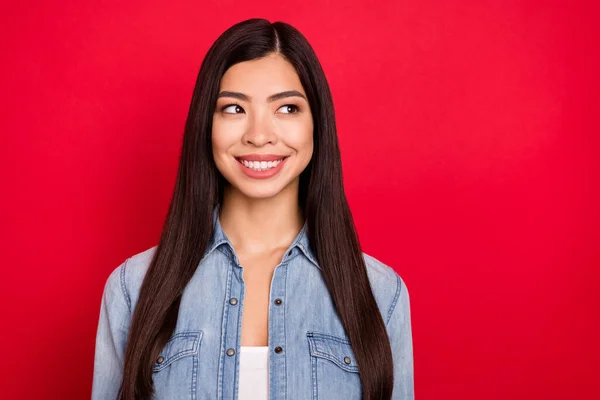 Foto de jovem atraente asiático menina feliz positivo sorriso curioso olhar vazio espaço isolado sobre vermelho cor fundo — Fotografia de Stock