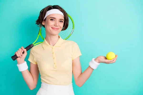 Parlak deniz mavisi turkuaz arka planda izole edilmiş tenis topunu elinde tutan güzel, neşeli kızın portresi. — Stok fotoğraf