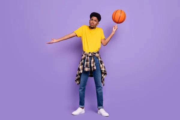 Foto em tamanho completo de infeliz afro-americano jovem sem noção homem segurar bola girar isolado no fundo cor violeta — Fotografia de Stock