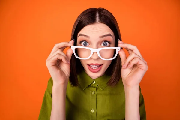 Photo of funky brunette hairdo millennial lady look wear eyewear khaki shirt isolated on orange color background — Stock Photo, Image