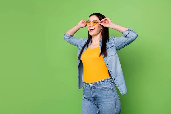 Photo of happy good mood cheerful woman in sunglass look copyspace enjoying dancing isolated on green color background — Stock Photo, Image