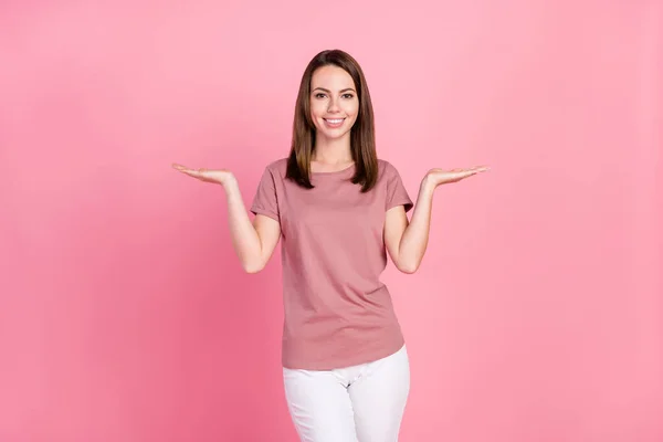 Retrato de menina alegre atraente segurando em palmas copiar anúncio espaço vazio isolado sobre fundo cor pastel rosa — Fotografia de Stock