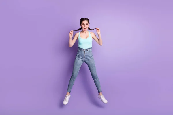 Full length body size view of cheerful girlish girl jumping having fun fooling isolated over violet purple color background —  Fotos de Stock